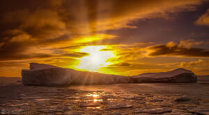 The sunset over a large ice slab in the southern ocean