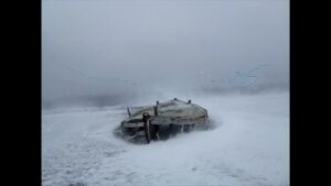 An old whaler’s boat gets battered in a blizzard in the Antarctic Peninsula